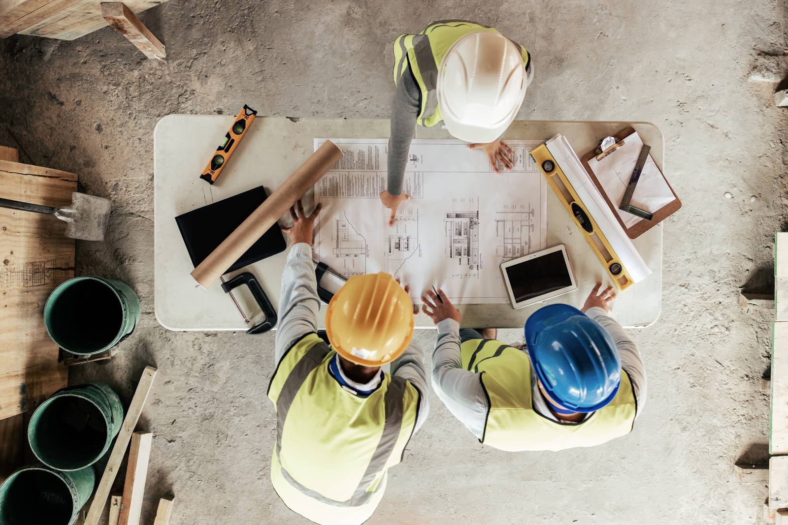 Trade team reviewing working drawings on a Queensland site